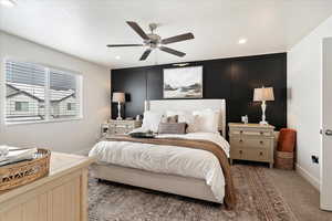 Bedroom featuring ceiling fan and dark colored carpet