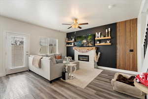 Living room with hardwood / wood-style flooring and ceiling fan