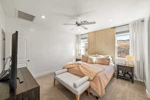 Carpeted bedroom featuring ceiling fan