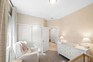 Bedroom featuring a closet and light colored carpet