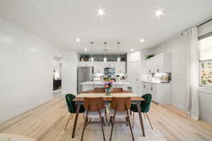 Dining room with light hardwood / wood-style floors