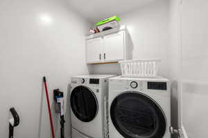 Laundry room with cabinets and washer and dryer