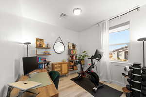 Home office with light wood-type flooring