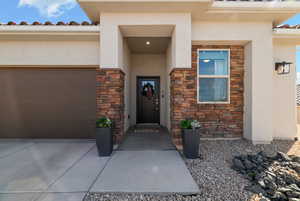 Doorway to property with a garage