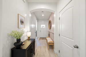 Foyer entrance with light wood-type flooring