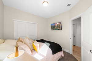 Bedroom featuring light hardwood / wood-style flooring and a closet