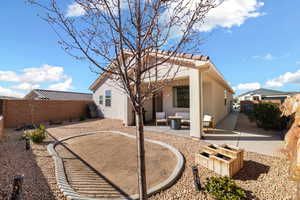 Rear view of house featuring a patio area and a fire pit