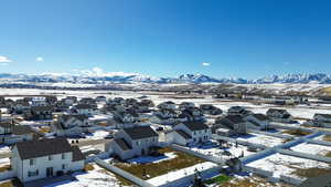 Snowy aerial view with a residential view and a mountain view