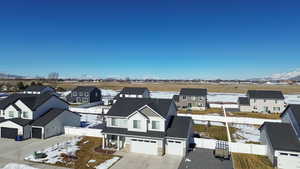 Snowy aerial view with a residential view and a mountain view