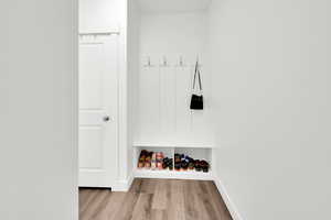 Mudroom with light hardwood / wood-style flooring