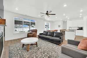 Living room featuring ceiling fan, hardwood / wood-style flooring, and sink