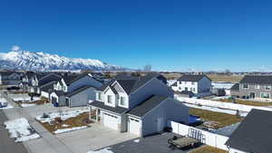 Snowy aerial view with a residential view and a mountain view