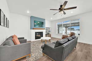 Living room featuring ceiling fan and wood-type flooring