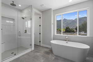 Bathroom featuring a mountain view and shower with separate bathtub