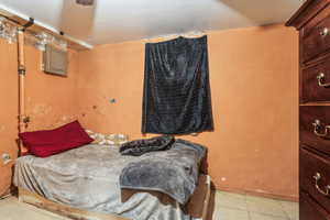 Tiled bedroom featuring electric panel