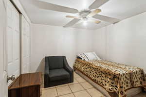 Bedroom featuring ceiling fan and light tile patterned flooring