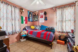 Bedroom featuring tile patterned flooring and ceiling fan