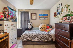 Tiled bedroom with ceiling fan