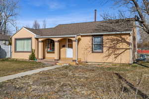 View of front of house featuring a porch and a front lawn