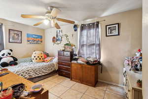 Tiled bedroom with ceiling fan