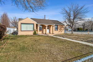 Single story home with a front lawn