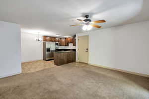 living room with light colored carpet and ceiling fan