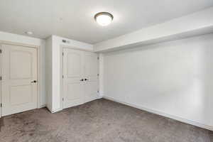 Unfurnished bedroom featuring light carpet and a closet