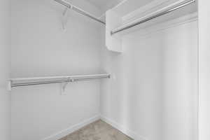 Walk in closet with carpet flooring