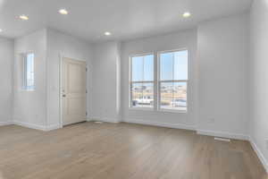 Spare room featuring light hardwood / wood-style flooring and a wealth of natural light