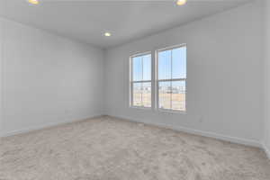 Spare room featuring light colored carpet