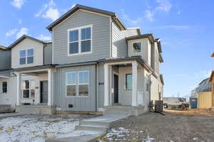 View of front of property with central AC unit