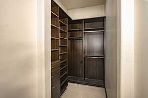 Walk in closet with light tile patterned floors