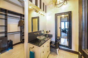 Bathroom with vanity, an inviting chandelier, and hardwood / wood-style floors