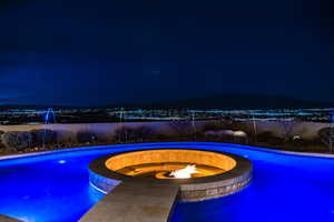 Pool at twilight with a fire pit