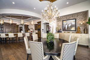 Dining space featuring a tray ceiling and dark hardwood / wood-style flooring