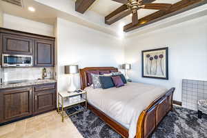 Bedroom featuring ceiling fan and beam ceiling