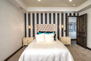 Bedroom featuring dark colored carpet