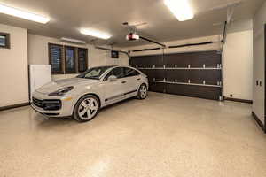 Garage with white refrigerator and a garage door opener