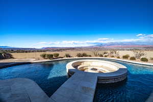 View of swimming pool featuring a mountain view and an outdoor fire pit