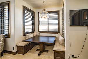 Home office with an inviting chandelier and breakfast area