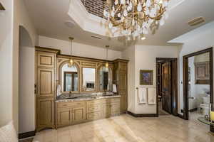 Bathroom with vanity, a raised ceiling, and toilet