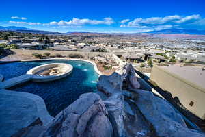 View of swimming pool featuring a hot tub, a mountain view, and pool water feature