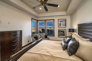 Bedroom featuring ceiling fan and a raised ceiling