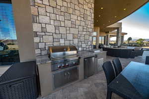 View of patio with outdoor lounge area, an outdoor kitchen, a grill, and sink