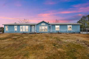 View of front of property featuring a lawn