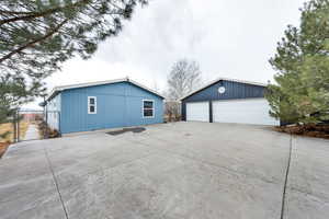 View of property exterior with an outbuilding and a garage