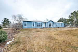 Ranch-style home with a front yard