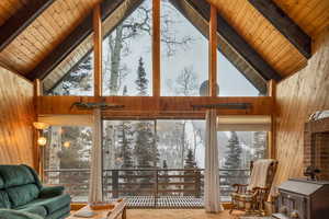 Sunroom with lofted ceiling with beams and wood ceiling