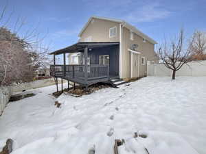 View of front of home with a wooden deck