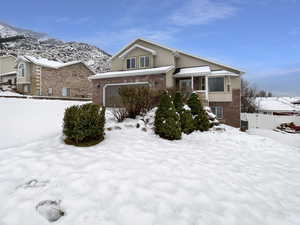 View of front facade with a mountain view and a garage